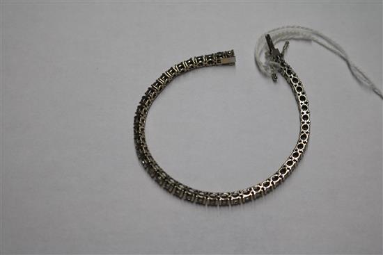 An 18ct white gold and diamond line bracelet, set with forty four round cut stones, with a total diamond weight of approximately